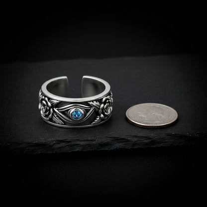 Eye of Horus ring next to a coin for scale