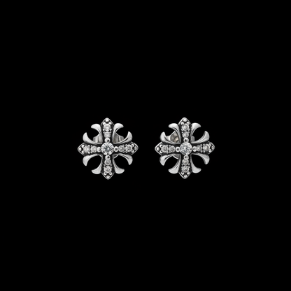 Pair of gothic pave cross stud earrings on a black background