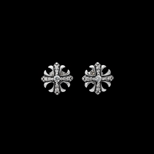 Pair of gothic pave cross stud earrings on a black background