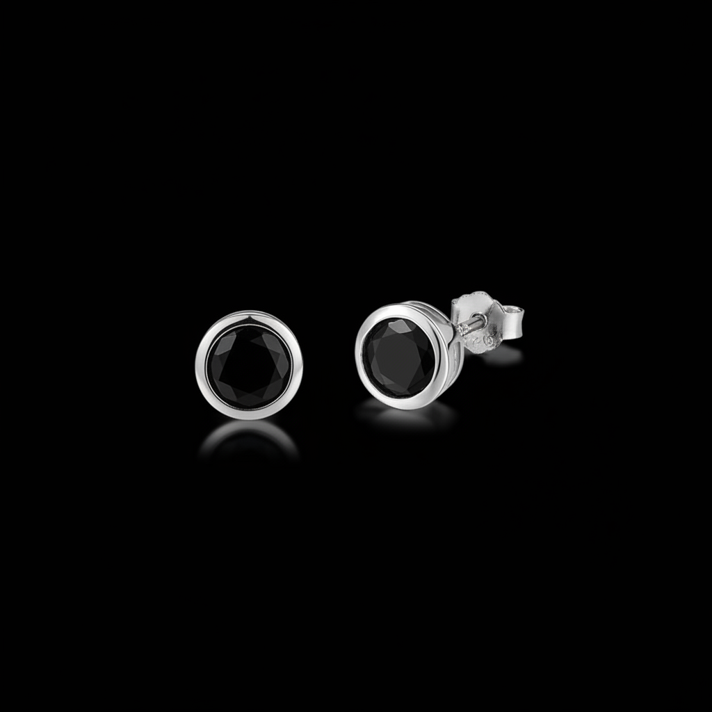 Pair of black onyx bezel-set stud earrings on a black background