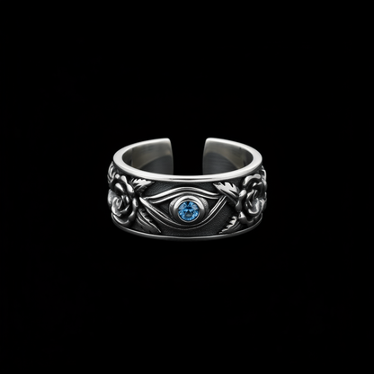 Antiqued silver Eye of Horus ring with blue stone on a black background