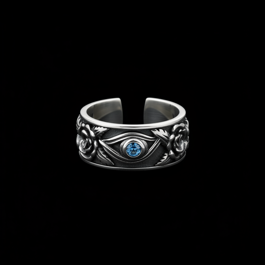Antiqued silver Eye of Horus ring with blue stone on a black background